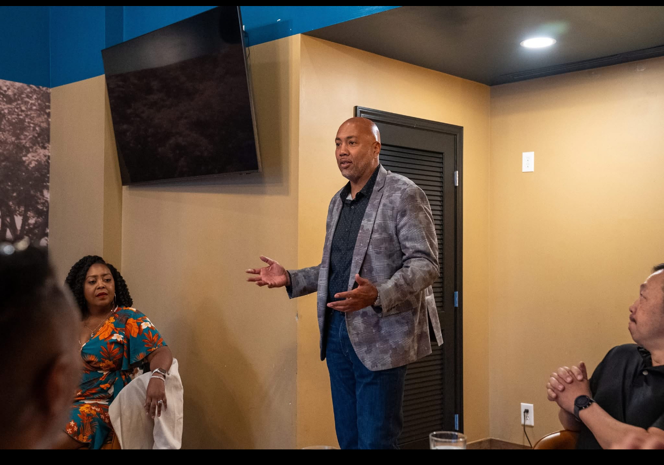 Shawn Morrison speaking in front of a live audience